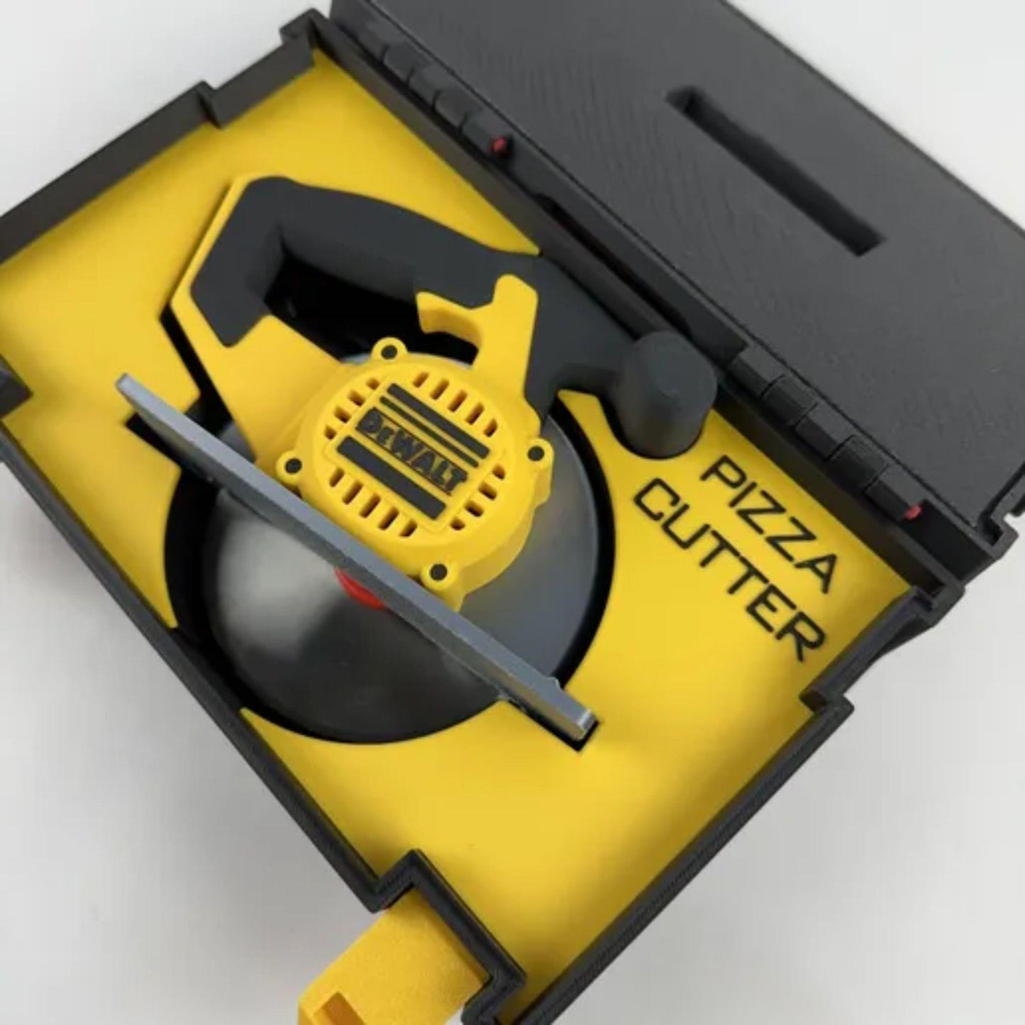 Yellow pizza cutter with black text 'PIZZA CUTTER' in a black and yellow case on a white background